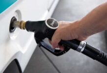 Trump Bets on Russian Diesel A hand holding a diesel fuel nozzle while refueling a vehicle