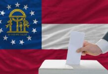 Georgia state flag with a hand casting a ballot